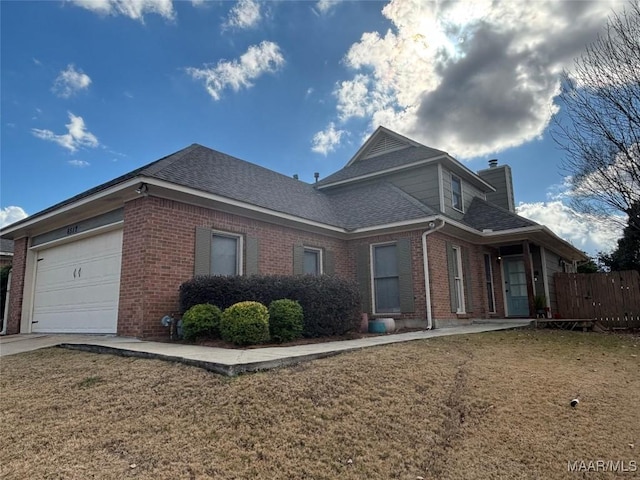 view of side of home featuring a yard and a garage