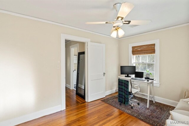 office area featuring wood-type flooring, ceiling fan, and crown molding