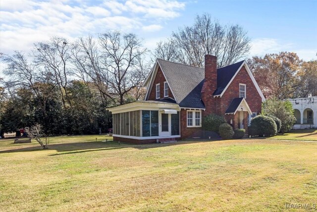 exterior space with a sunroom and a yard