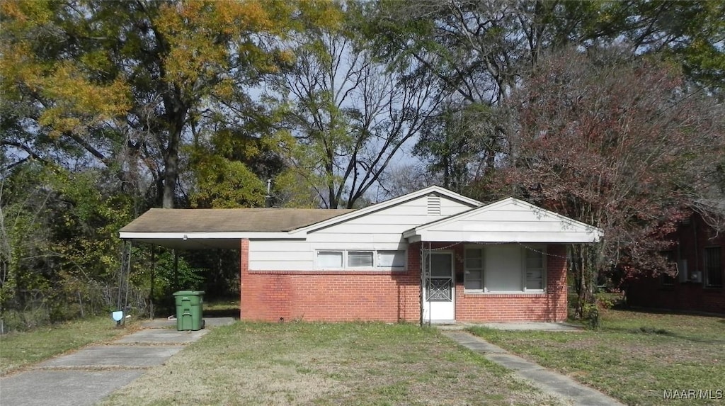 bungalow with a front lawn, a porch, and a carport