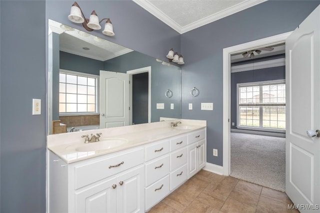 bathroom featuring tile patterned floors, vanity, a healthy amount of sunlight, and crown molding