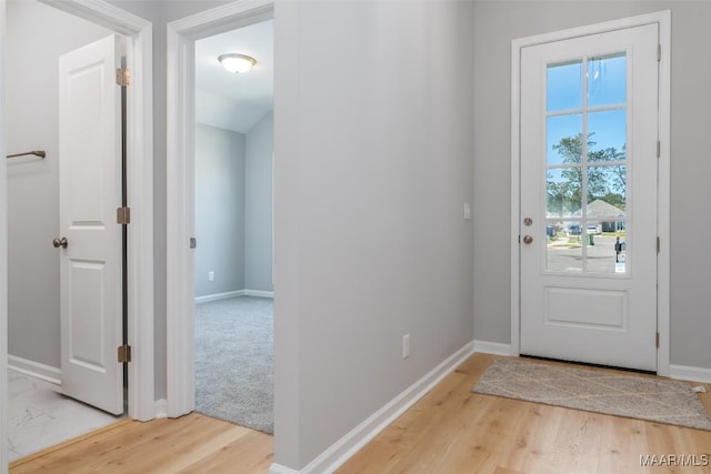 entryway featuring light wood-style floors and baseboards