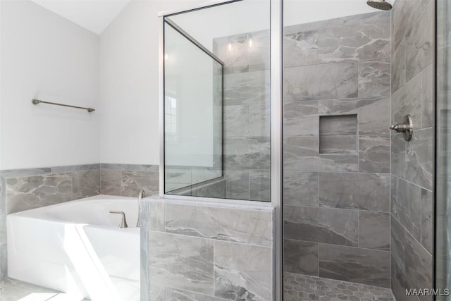 bathroom with a garden tub and a shower stall