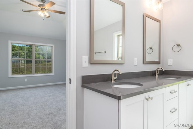 bathroom with a healthy amount of sunlight, double vanity, and a sink