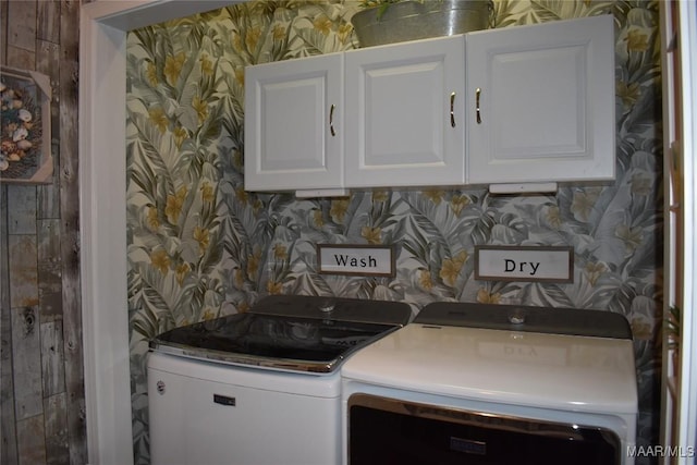 clothes washing area with cabinets and independent washer and dryer