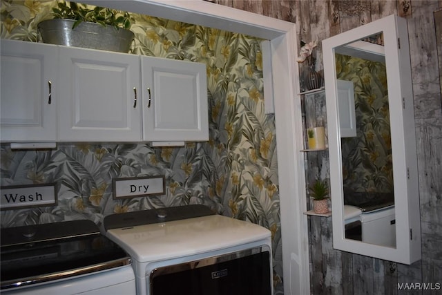 washroom featuring cabinets and independent washer and dryer