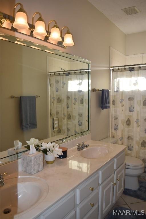 bathroom with tile patterned flooring, vanity, toilet, and a shower with shower curtain