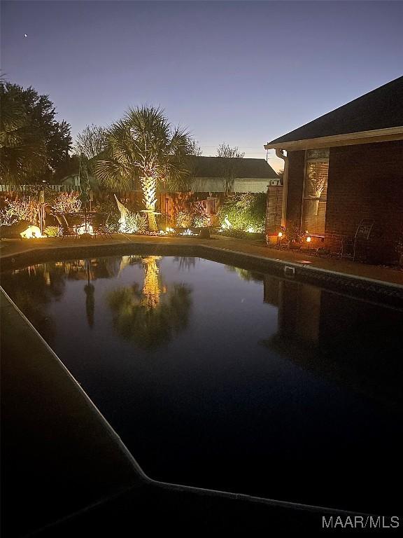 view of pool at dusk