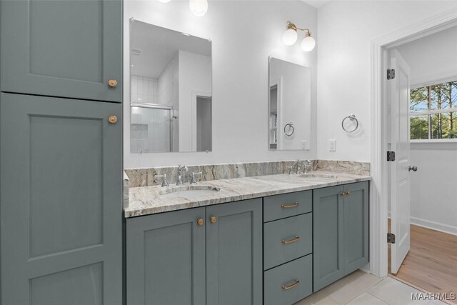 2065 Robinson Pond Rd, Prattville, AL 36067 - bathroom with tile patterned floors, a sink, double vanity, and a stall shower