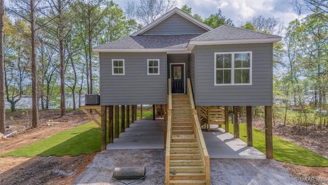 2065 Robinson Pond Rd, Prattville, AL 36067 - view of front of house with central AC, driveway, a carport, a shingled roof, and stairs
