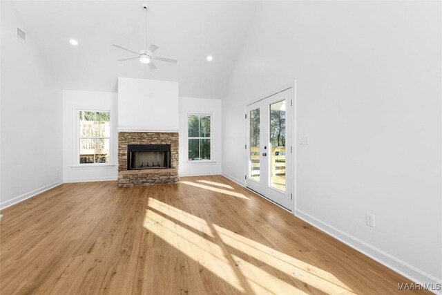2065 Robinson Pond Rd, Prattville, AL 36067 - unfurnished living room featuring a stone fireplace, a wealth of natural light, high vaulted ceiling, and visible vents
