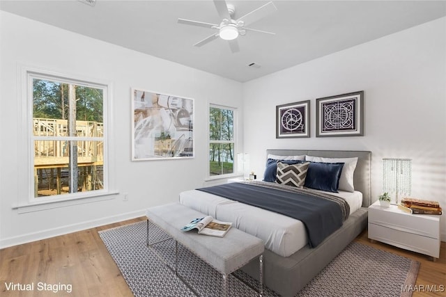 2065 Robinson Pond Rd, Prattville, AL 36067 - bedroom featuring baseboards, wood finished floors, and multiple windows