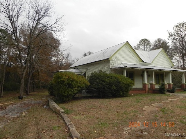 view of side of home with a porch