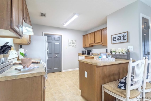 kitchen featuring a breakfast bar and sink