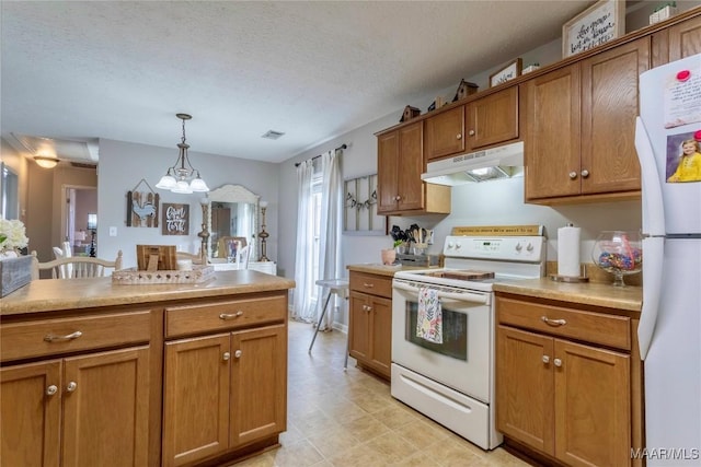 kitchen with a textured ceiling, decorative light fixtures, white appliances, and an inviting chandelier