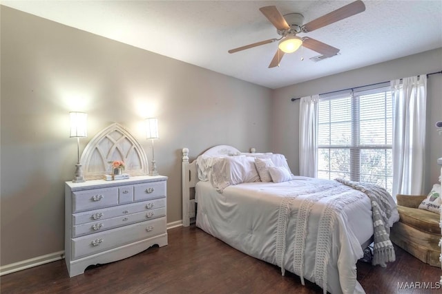 bedroom with dark hardwood / wood-style floors and ceiling fan