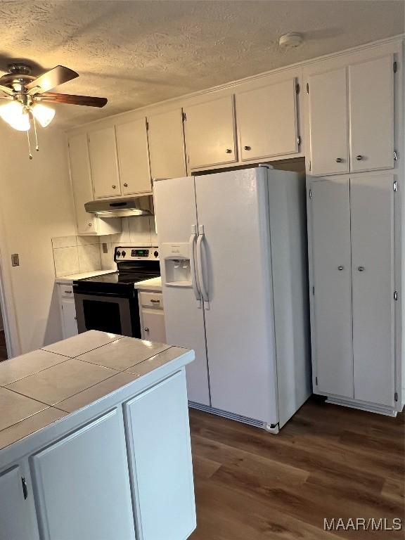 kitchen with white cabinetry, electric range, white fridge with ice dispenser, ceiling fan, and dark wood-type flooring