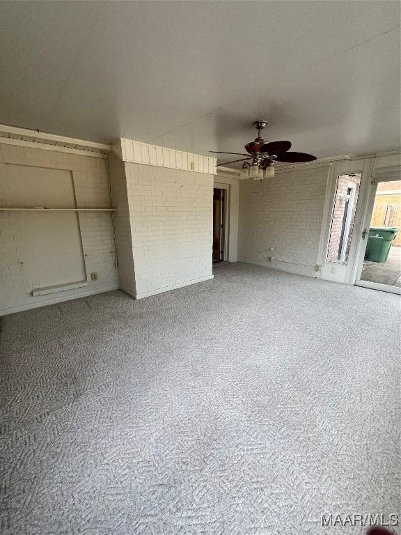 interior space with carpet and ceiling fan