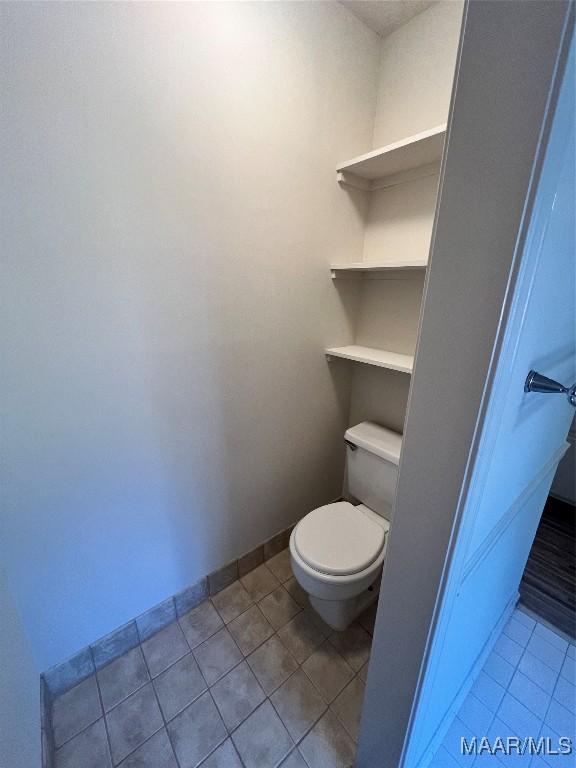 bathroom with tile patterned flooring and toilet