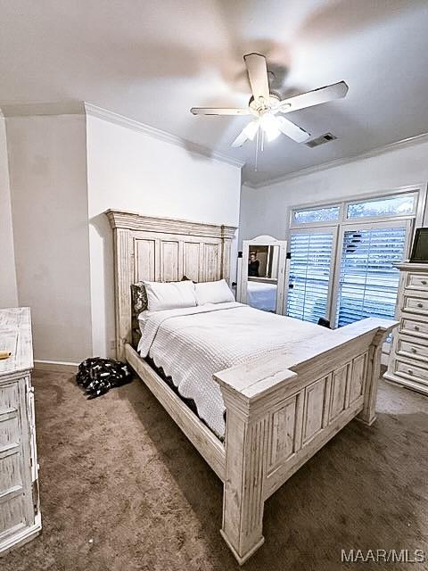 carpeted bedroom featuring ceiling fan and crown molding