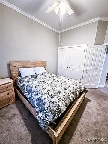 carpeted bedroom featuring a closet, ceiling fan, and ornamental molding