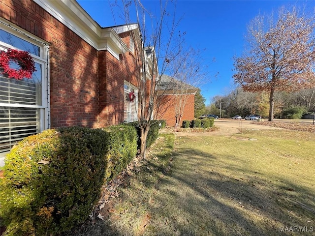 view of side of property with a yard