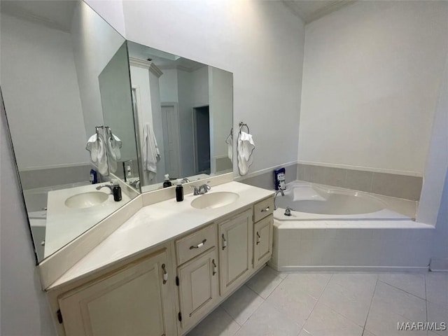 bathroom with tile patterned flooring, vanity, and a relaxing tiled tub