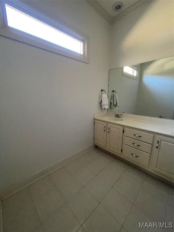 bathroom with tile patterned flooring, vanity, and ornamental molding