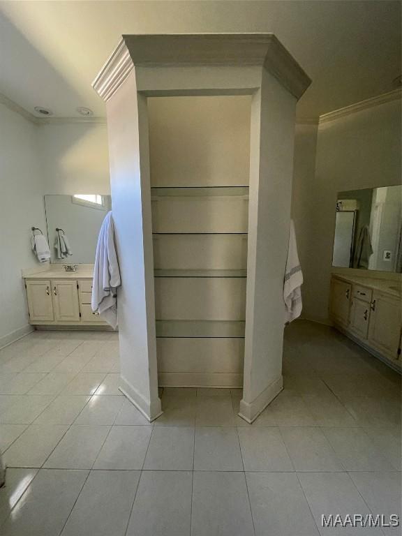 bathroom with tile patterned floors, vanity, and ornamental molding