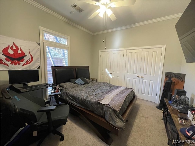 bedroom with ceiling fan, a closet, light colored carpet, and ornamental molding