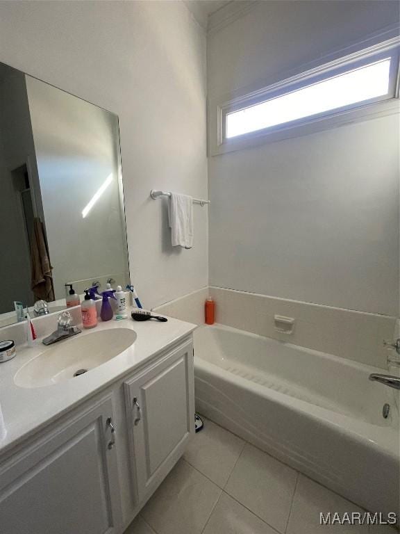 bathroom featuring tile patterned floors, vanity, and a bathtub