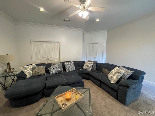 living room with ceiling fan, light colored carpet, and ornamental molding