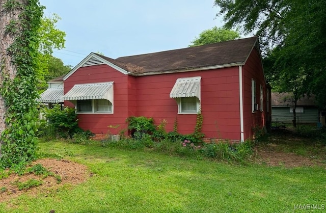 view of property exterior with a yard