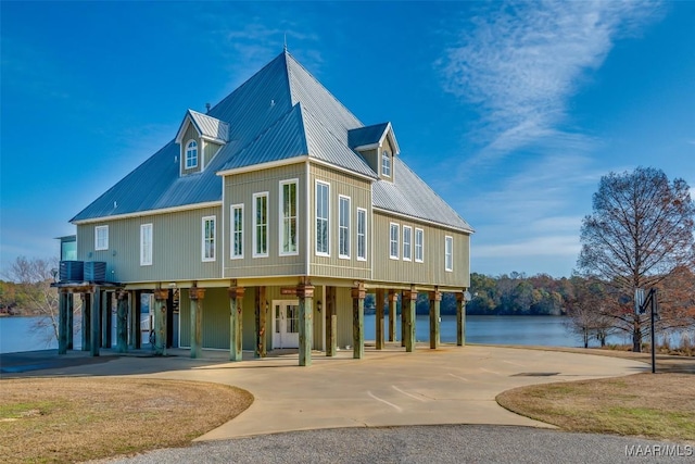 exterior space featuring central AC, a water view, and a carport