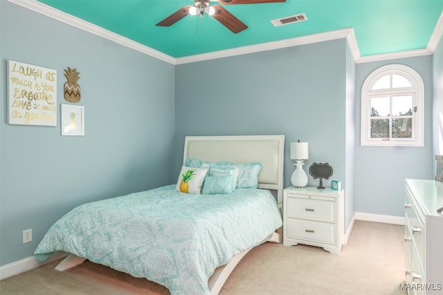 carpeted bedroom featuring ceiling fan and crown molding