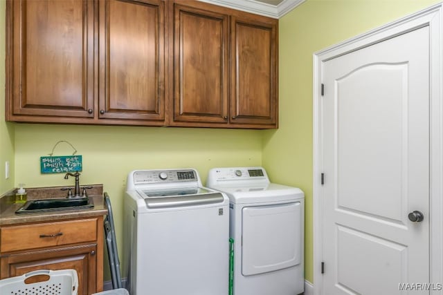 washroom with washer and dryer, cabinets, sink, and crown molding