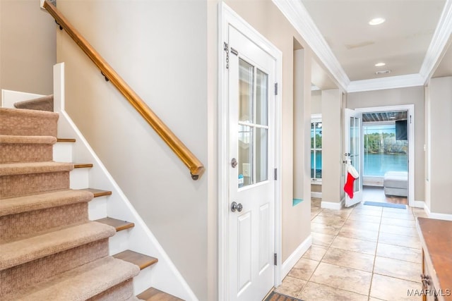 stairway featuring tile patterned floors and ornamental molding