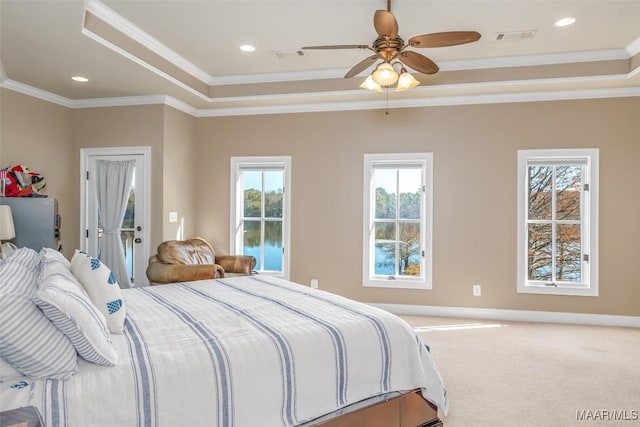 bedroom with carpet flooring, a raised ceiling, ceiling fan, and ornamental molding