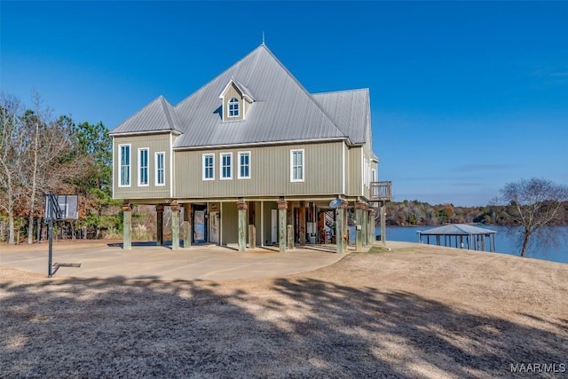 back of property featuring a water view