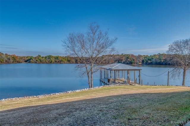 dock area featuring a water view and a lawn