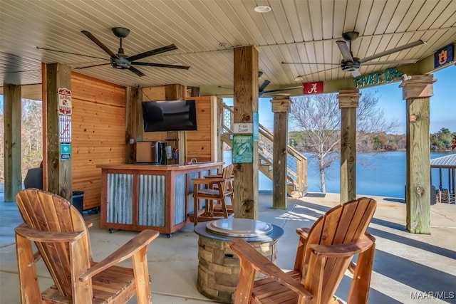 view of patio with exterior bar and ceiling fan