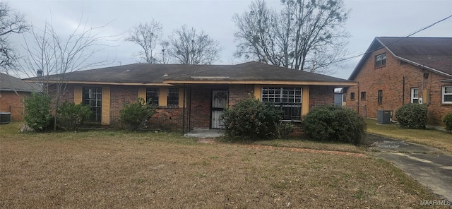 view of front of home with a front lawn and central AC unit