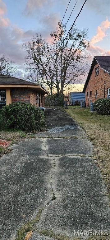 property exterior at dusk featuring central AC