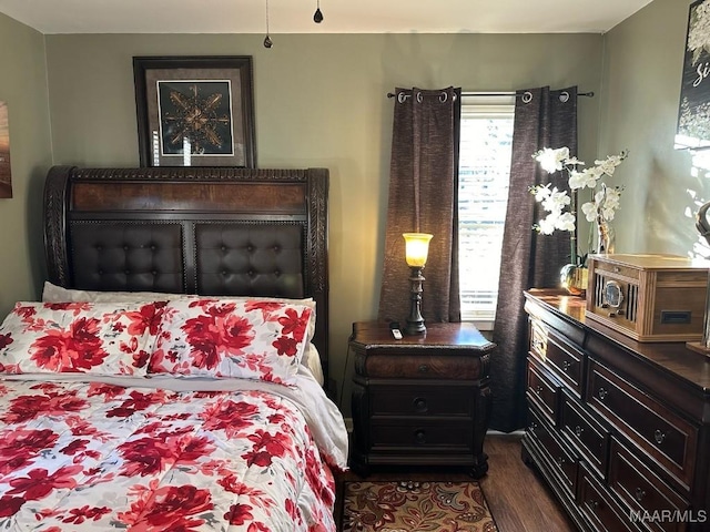 bedroom featuring dark hardwood / wood-style floors and multiple windows