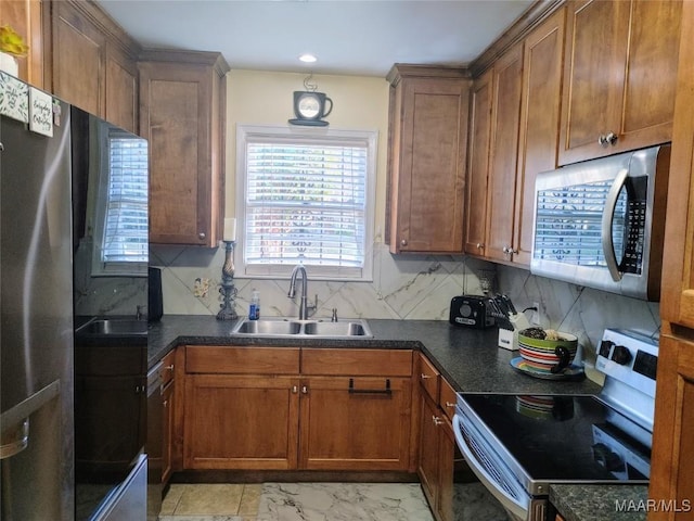 kitchen featuring sink, backsplash, and appliances with stainless steel finishes