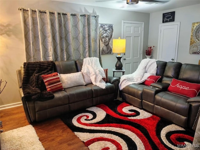 living room featuring hardwood / wood-style flooring and ceiling fan