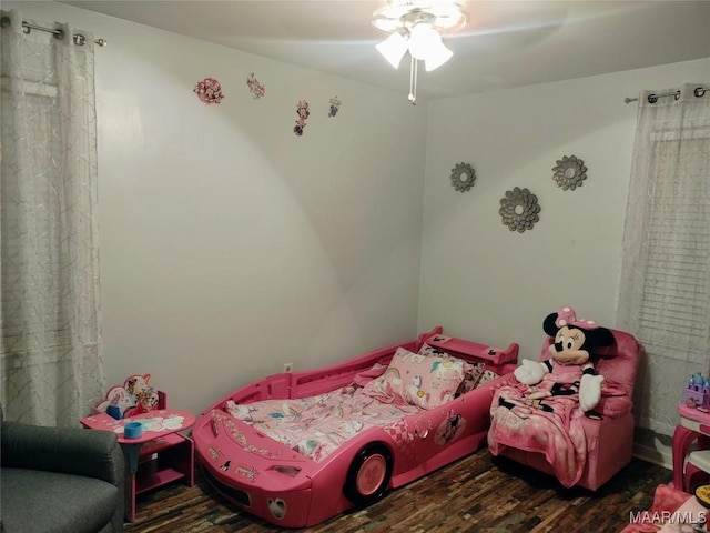 bedroom with ceiling fan and dark wood-type flooring