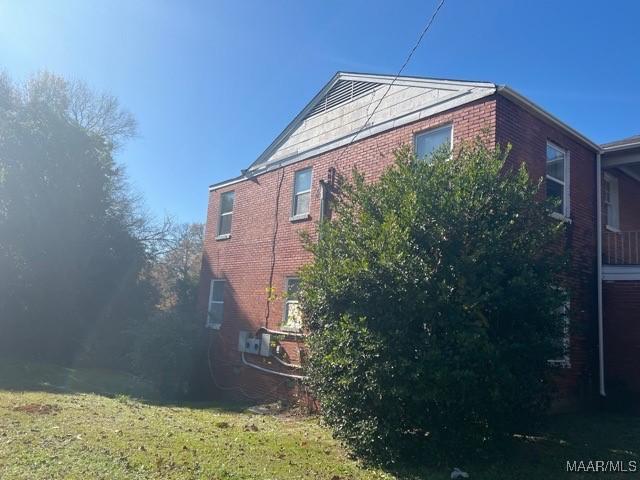 view of side of home featuring a lawn