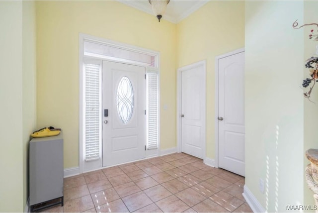 entrance foyer featuring light tile patterned floors and ornamental molding