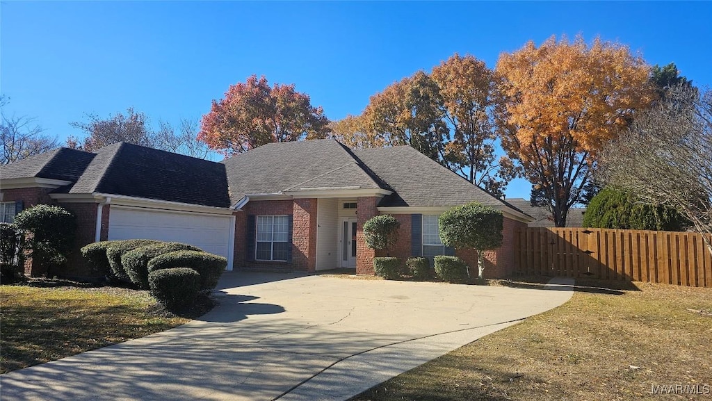 view of front of home with a front yard and a garage